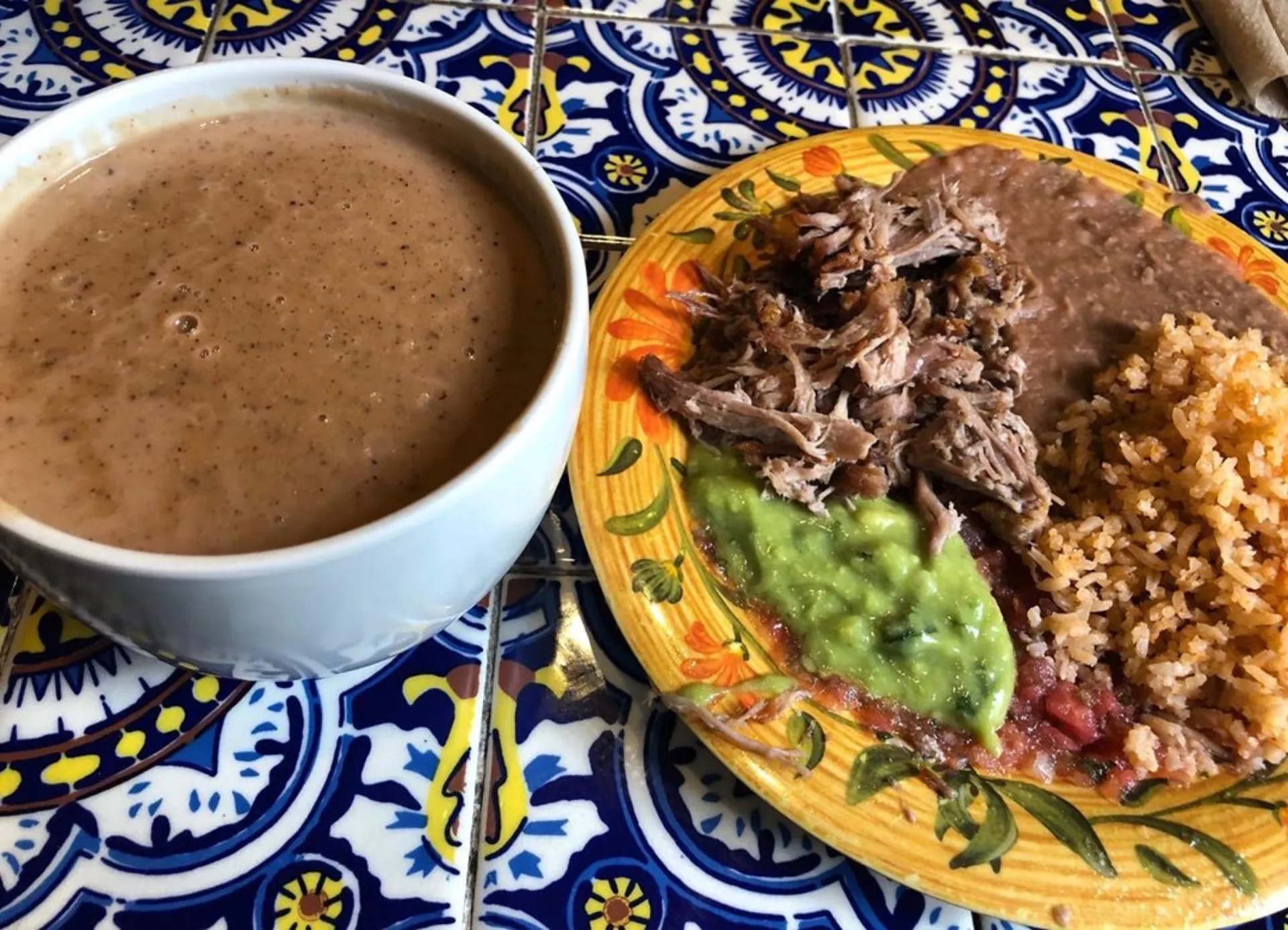 Champurrado and carnitas plate at La Luz del Dia on Olvera Street