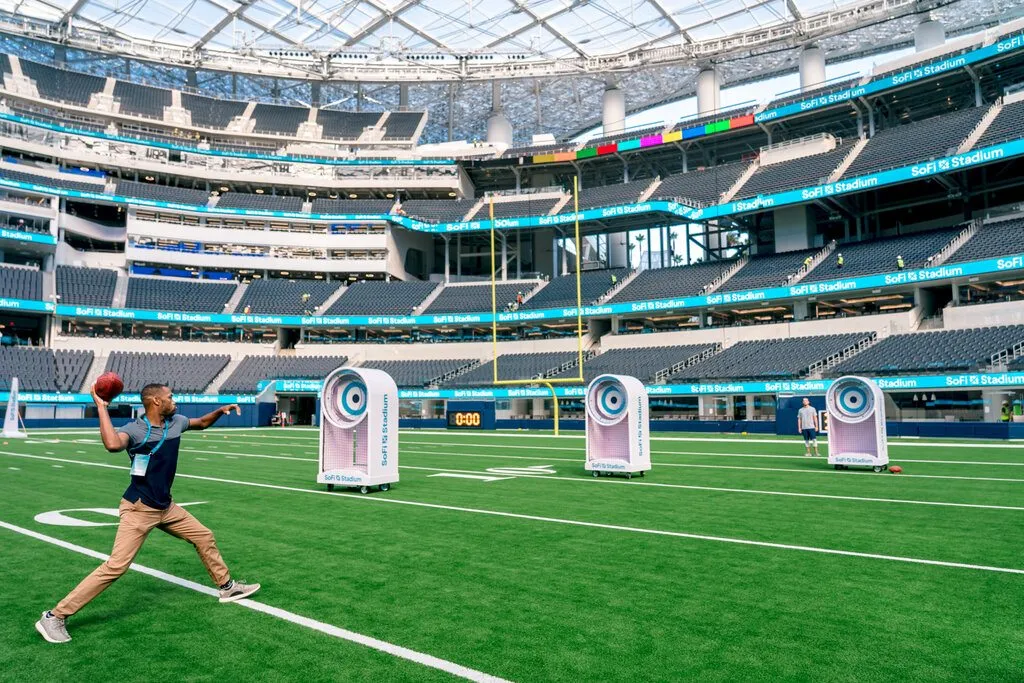 A guest throws a football at targets on the SoFi Stadium Tour.
