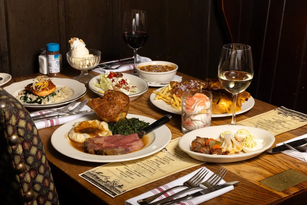 A table set with appetizers, dinner, and dessert.